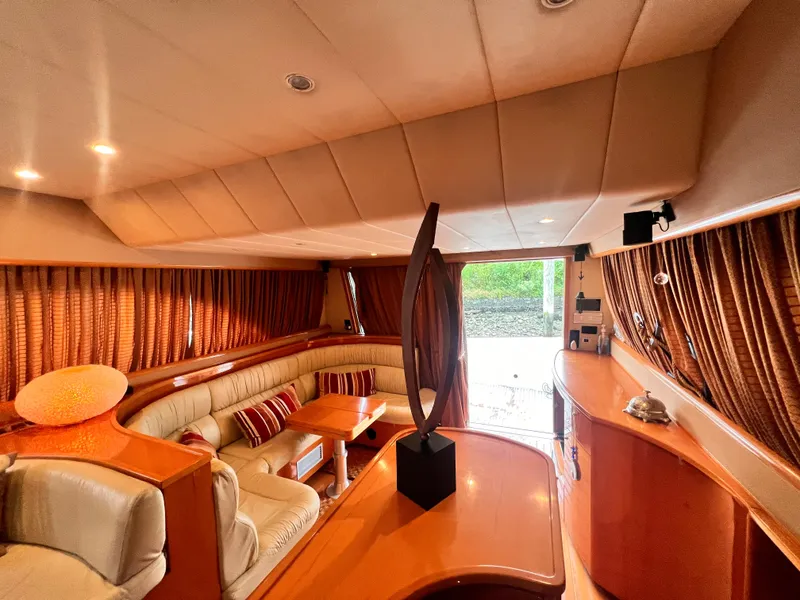 Slide: The Image of Luxurious interior of a 2001 Uniesse Flybridge 48 yacht with elegant seating and decor. - 13