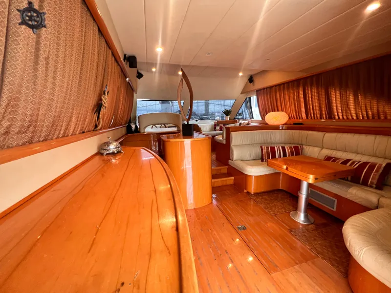 Slide: The Image of Luxurious interior of 2001 Uniesse Flybridge 48 yacht with wooden finishes and plush seating. - 17
