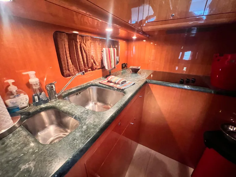 Slide: The Image of 2001 Uniesse Flybridge 48 yacht kitchen with dual sinks and marble countertops. - 18