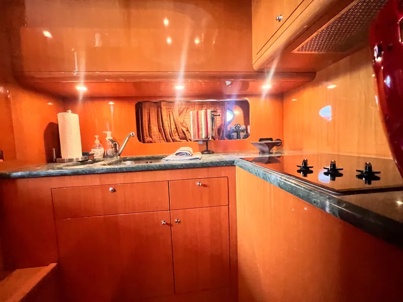 Slide: The Image of 2001 Uniesse Flybridge 48 yacht kitchen with wooden cabinets and modern appliances. - 20