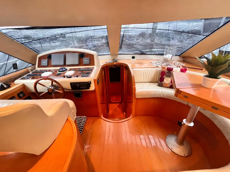 Slide: The Image of Interior of 2001 Uniesse Flybridge 48 yacht with helm, seating, and table. - 21