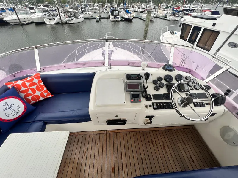 Slide: The Image of Flybridge helm of 2001 Uniesse Flybridge 48 yacht with marina view. - 28