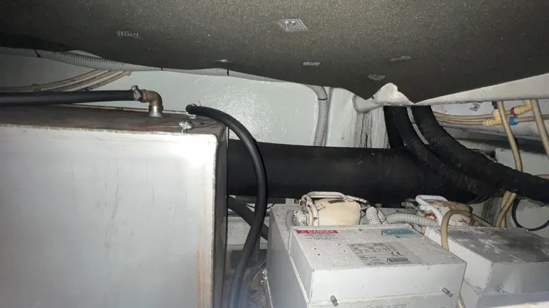 Slide: The Image of Engine room of a 2001 Uniesse Flybridge 48 yacht showing machinery and wiring. - 34