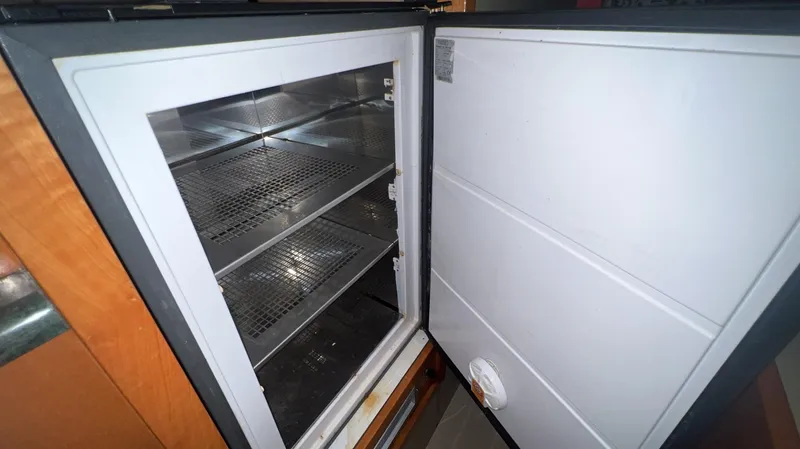 Slide: The Image of Open refrigerator inside a 2001 Uniesse Flybridge 48 yacht. - 39