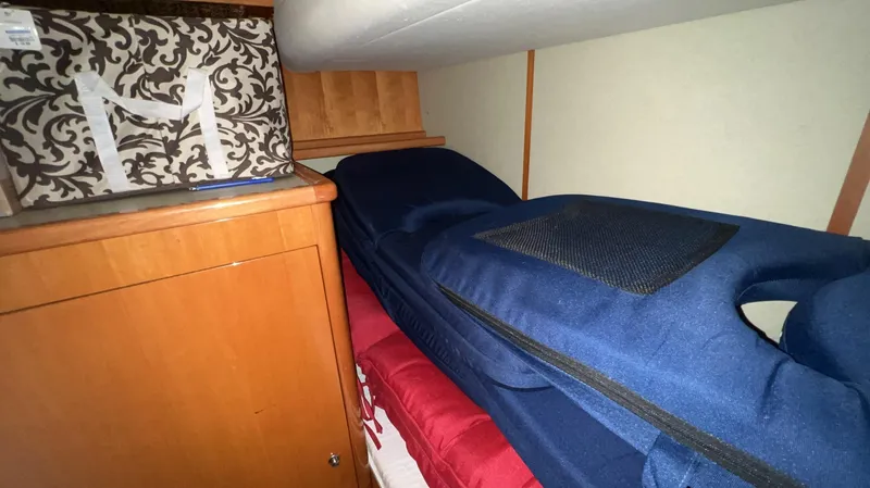 Slide: The Image of Interior cabin of a 2001 Uniesse Flybridge 48 yacht with storage and bedding. - 42