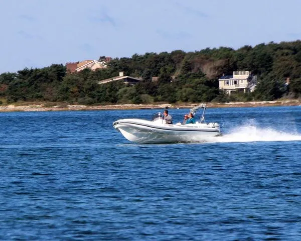 The Image of 2024 Zar Formenti 53 boat speeding on a lake with houses and trees in the background. - 0