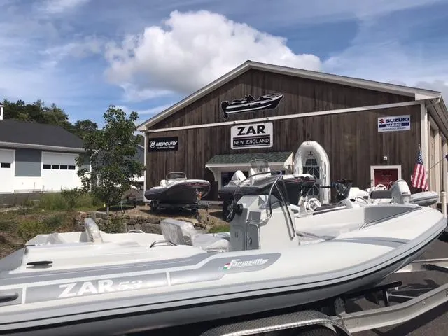 Slide: The Image of Zar Formenti 53 boat at dealership, 2024 model, displayed outside showroom. - 2
