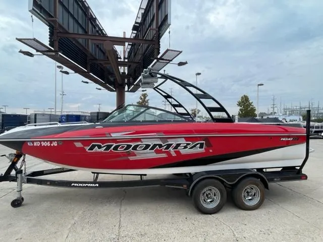 Slide: The Image of 2012 Moomba Mojo 2.5 red and white boat on a trailer. - 1