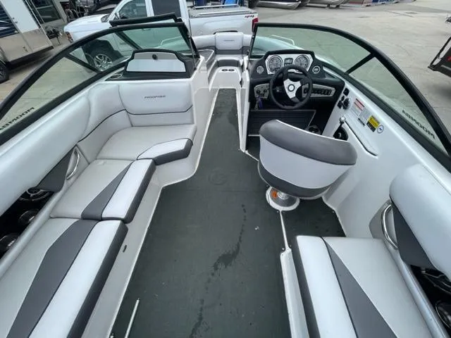 Slide: The Image of 2012 Moomba Mojo 2.5 boat interior with white and gray seating, steering console, and windshield. - 10