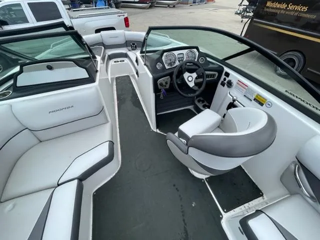 Slide: The Image of 2012 Moomba Mojo 2.5 boat interior with seating and steering console. - 11