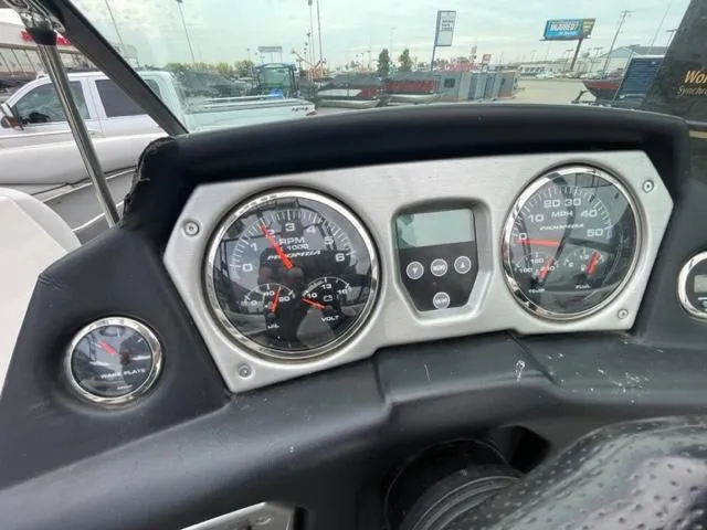 Slide: The Image of Dashboard of a 2012 Moomba Mojo 2.5 boat with gauges and controls. - 14