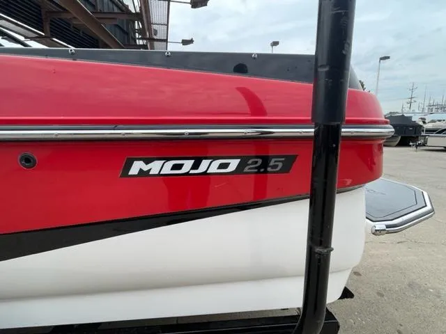 Slide: The Image of 2012 Moomba Mojo 2.5 boat, red and white exterior, docked. - 2
