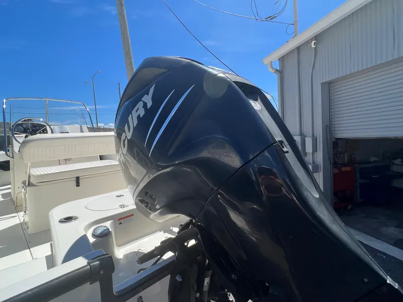Slide: The Image of 2009 Boston Whaler 190 Outrage with Mercury outboard motor in a marina. - 5
