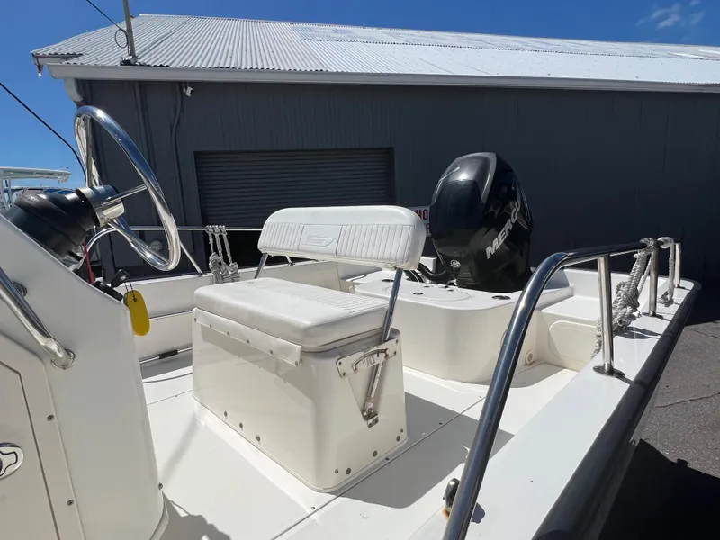 Slide: The Image of 2009 Boston Whaler 190 Outrage boat interior with seating and steering wheel. - 8