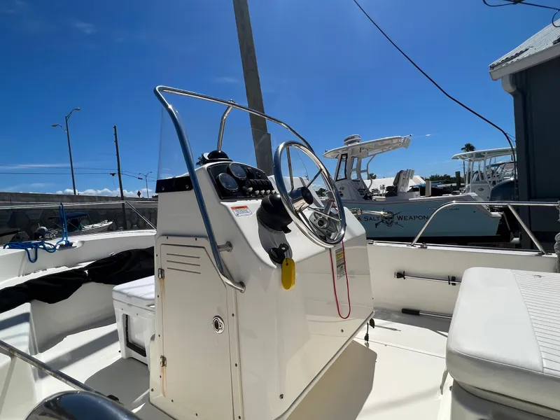 Slide: The Image of 2009 Boston Whaler 190 Outrage boat interior with steering console and seating. - 9
