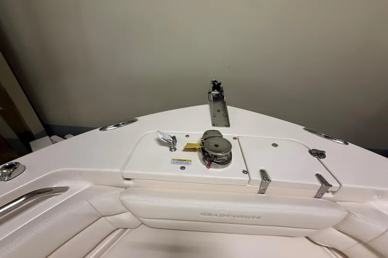 Slide: The Image of 2026 Grady-White Fisherman 236 boat interior, featuring sleek white seating and deck details. - 12