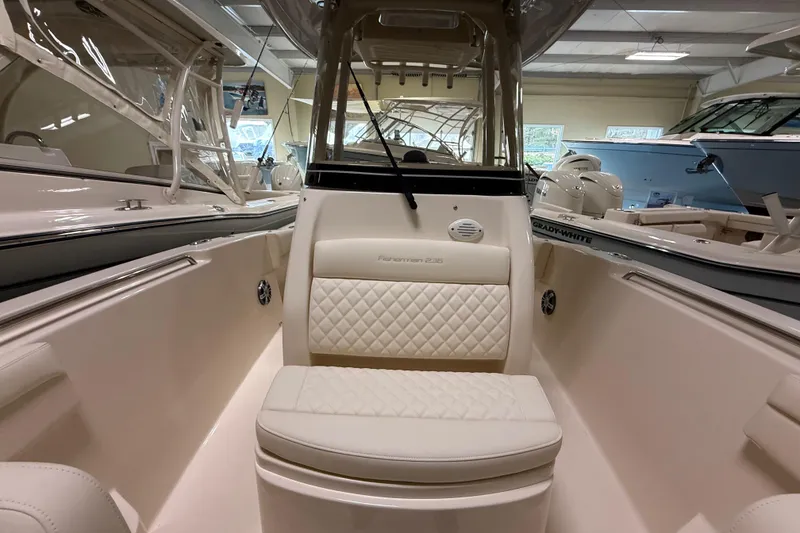 Slide: The Image of 2026 Grady-White Fisherman 236 boat interior with cushioned seating and sleek design. - 13