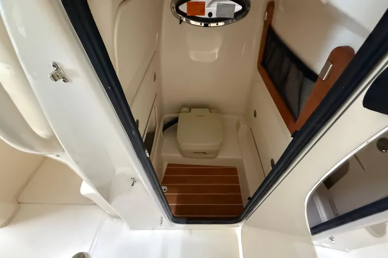 Slide: The Image of 2026 Grady-White Fisherman 236 boat interior with compact marine toilet. - 9