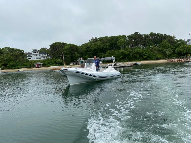 Slide: The Image of 2024 Zar Formenti 59 SL Limited boat cruising near a scenic shoreline. - 3