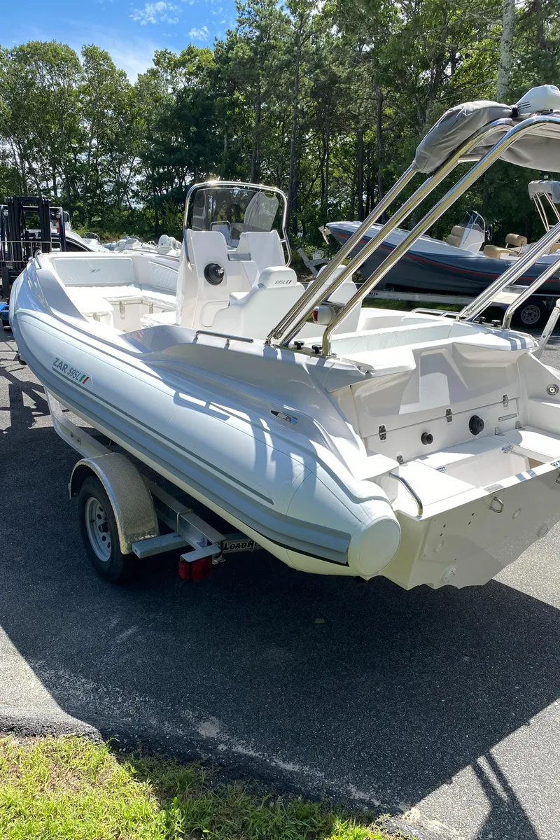 Slide: The Image of 2024 Zar Formenti 59 SL Limited boat on a trailer in a sunny outdoor setting. - 5