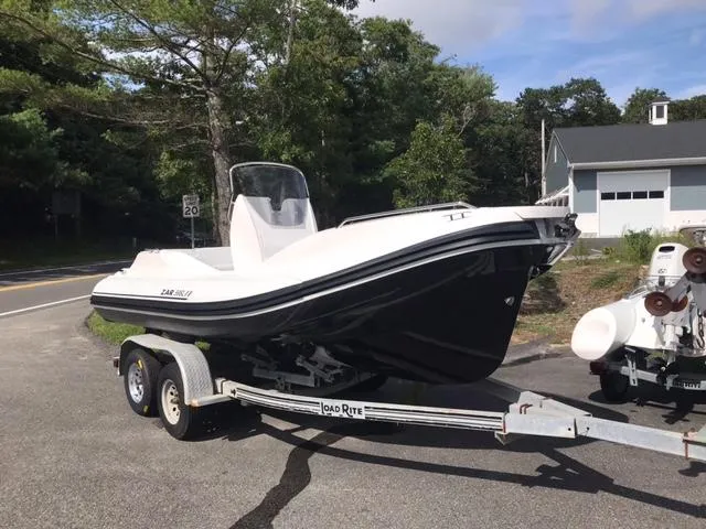 The Image of 2024 Zar Formenti 59 SL boat displayed indoors with Mercury engine. - 0