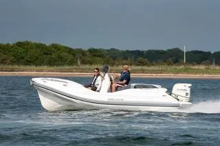 Slide: The Image of 2024 Zar Formenti 59 SL boat cruising on water with passengers, scenic background. - 11