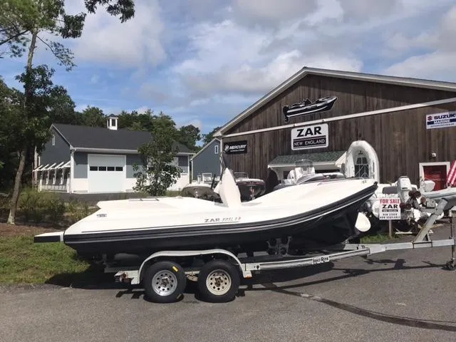 Slide: The Image of 2024 Zar Formenti 59 SL boat displayed outdoors at a dealership. - 3