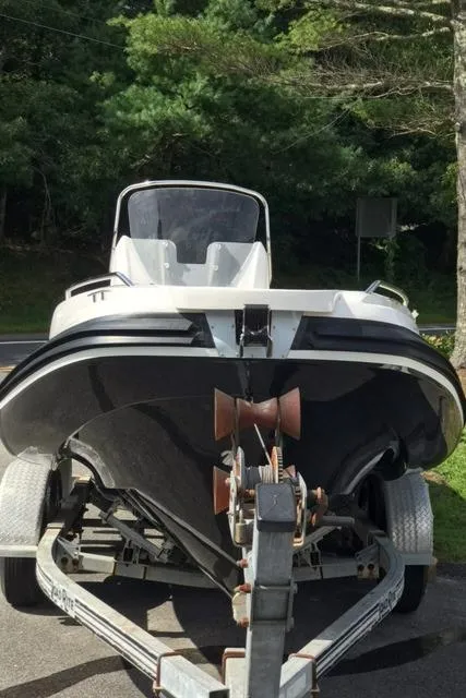 Slide: The Image of 2024 Zar Formenti 59 SL boat on a trailer outside a dealership. - 4