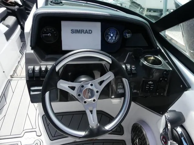 Slide: The Image of 2024 Monterey M-65 boat dashboard with steering wheel and Simrad display. - 10