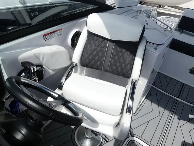 Slide: The Image of 2024 Monterey M-65 boat cockpit with white and black seating, steering wheel, and modern design. - 11
