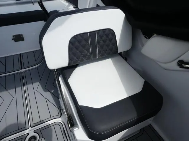 Slide: The Image of 2024 Monterey M-65 boat seat with black and white upholstery, featuring diamond stitching. - 12