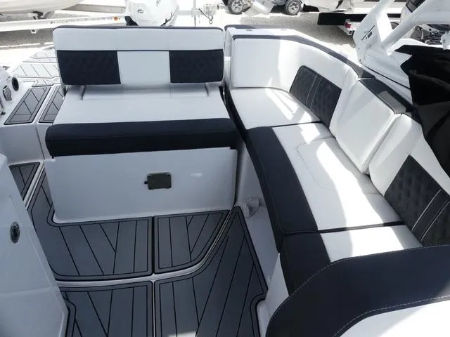 Slide: The Image of 2024 Monterey M-65 boat interior with sleek black and white seating design. - 15