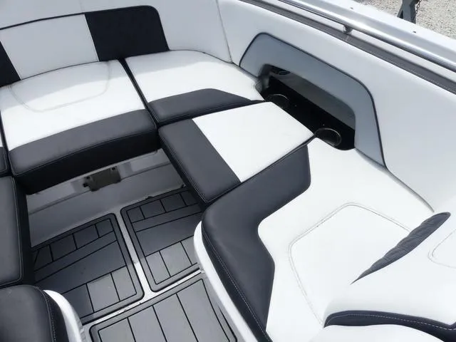 Slide: The Image of 2024 Monterey M-65 boat interior with sleek black and white seating design. - 20