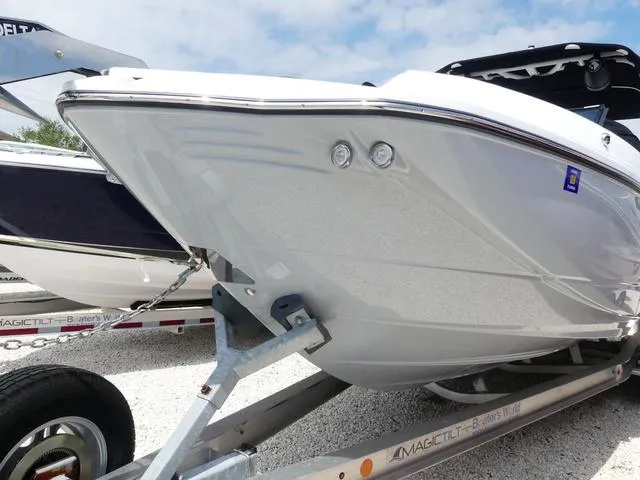 Slide: The Image of 2024 Monterey M-65 boat on trailer, showcasing sleek white hull design. - 3