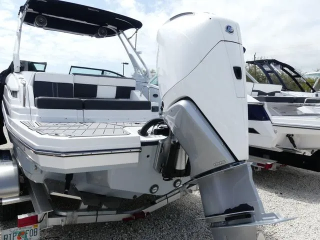 Slide: The Image of 2024 Monterey M-65 boat with powerful outboard motor, sleek design, and spacious seating. - 6