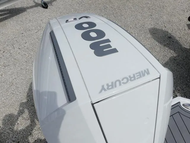 Slide: The Image of 2024 Monterey M-65 boat with Mercury 300 V8 engine on gravel surface. - 8