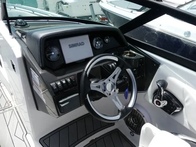 Slide: The Image of 2024 Monterey M-65 boat dashboard with steering wheel, Simrad display, and control panel. - 9