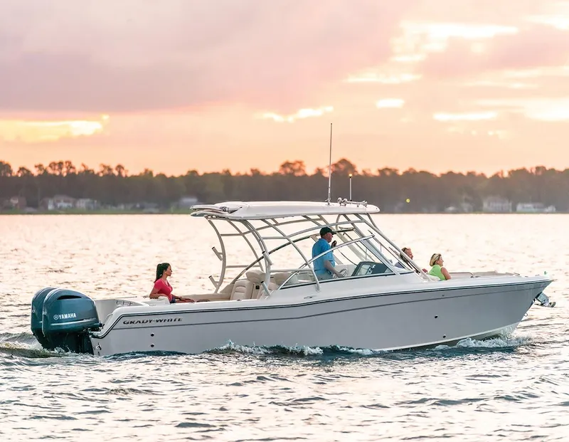 Slide: The Image of 2024 Grady-White 285 Freedom boat cruising on water at sunset. - 1