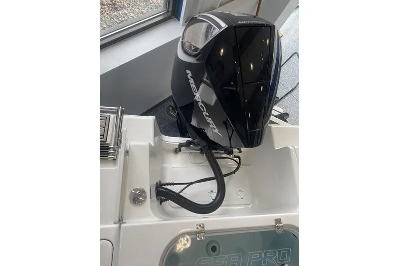 Slide: The Image of 2024 Sea Pro 242 Center Console with Mercury outboard engine in showroom. - 18