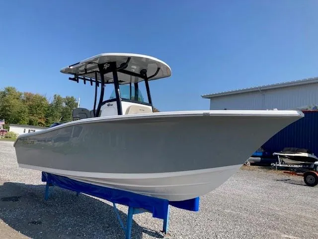 Slide: The Image of 2024 Sea Pro 242 Center Console boat on trailer in spacious indoor showroom. - 2