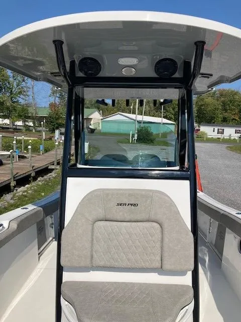 Slide: The Image of 2024 Sea Pro 242 DLX boat with T-top and cushioned seating. - 24