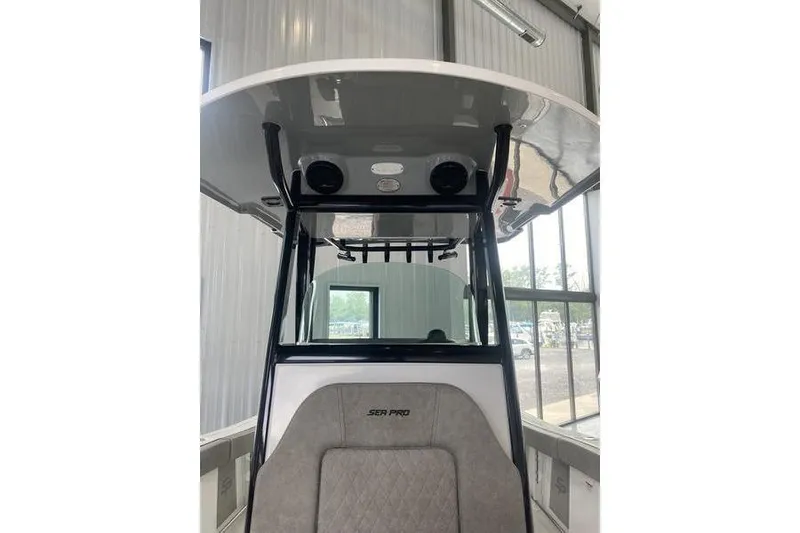 Slide: The Image of 2024 Sea Pro 242 Center Console boat interior with T-top and seating. - 25