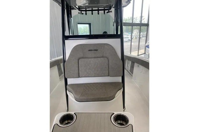 Slide: The Image of 2024 Sea Pro 242 Center Console boat interior with cushioned seating and cup holders. - 26
