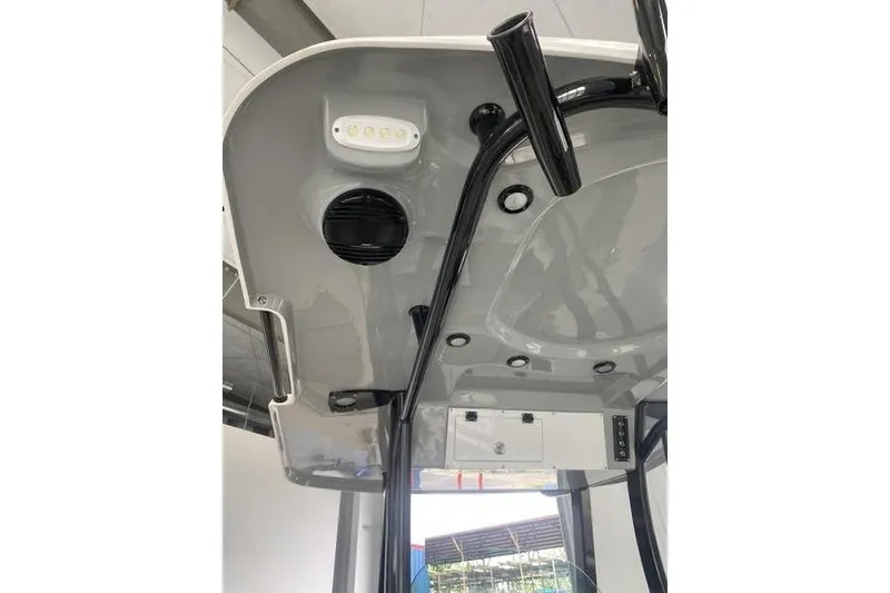 Slide: The Image of 2024 Sea Pro 242 Center Console boat interior, featuring overhead lighting and storage compartments. - 27