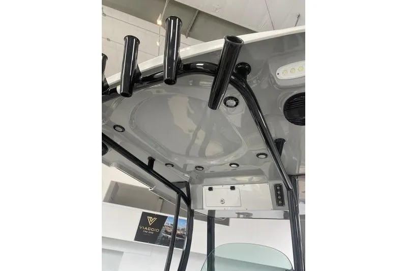 Slide: The Image of 2024 Sea Pro 242 Center Console boat's T-top with rod holders and LED lights. - 29