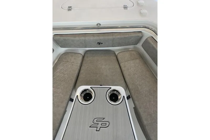 Slide: The Image of 2024 Sea Pro 242 Center Console boat interior with cushioned seating and cup holders. - 40