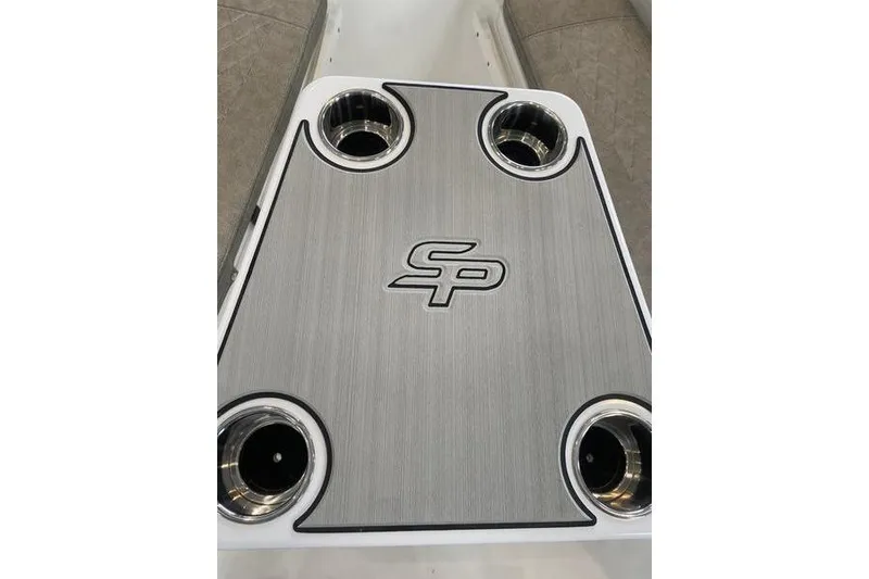 Slide: The Image of 2024 Sea Pro 242 Center Console boat table with cup holders and logo. - 41