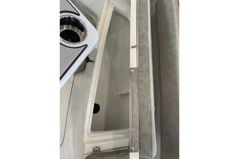 Slide: The Image of 2024 Sea Pro 242 Center Console interior with storage compartment and cup holder. - 43