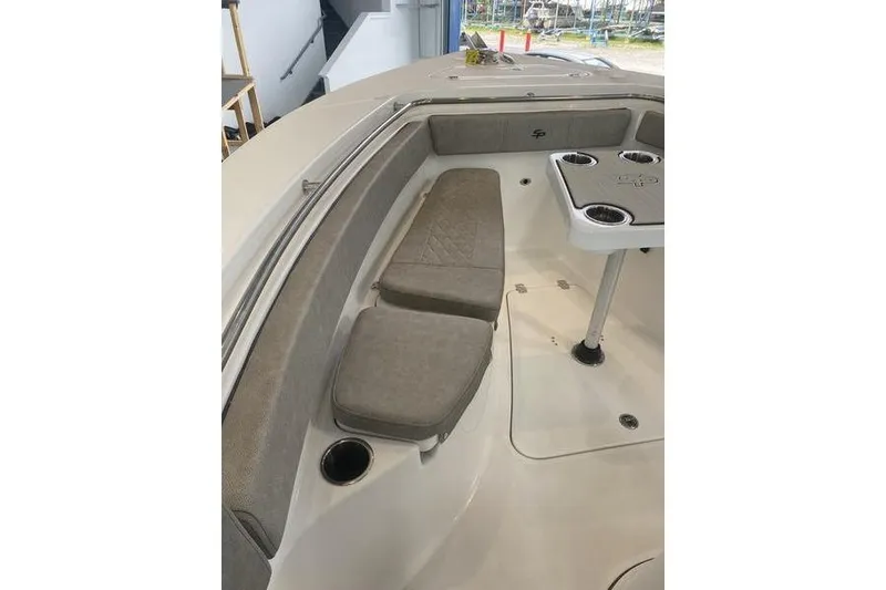 Slide: The Image of 2024 Sea Pro 242 Center Console boat interior with cushioned seating and cup holders. - 45