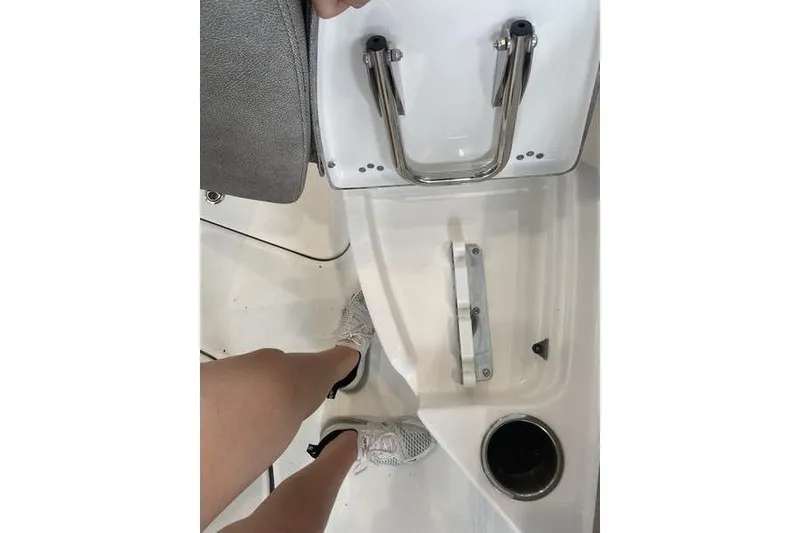 Slide: The Image of 2024 Sea Pro 242 Center Console boat interior with stainless steel fixtures and cup holder. - 48
